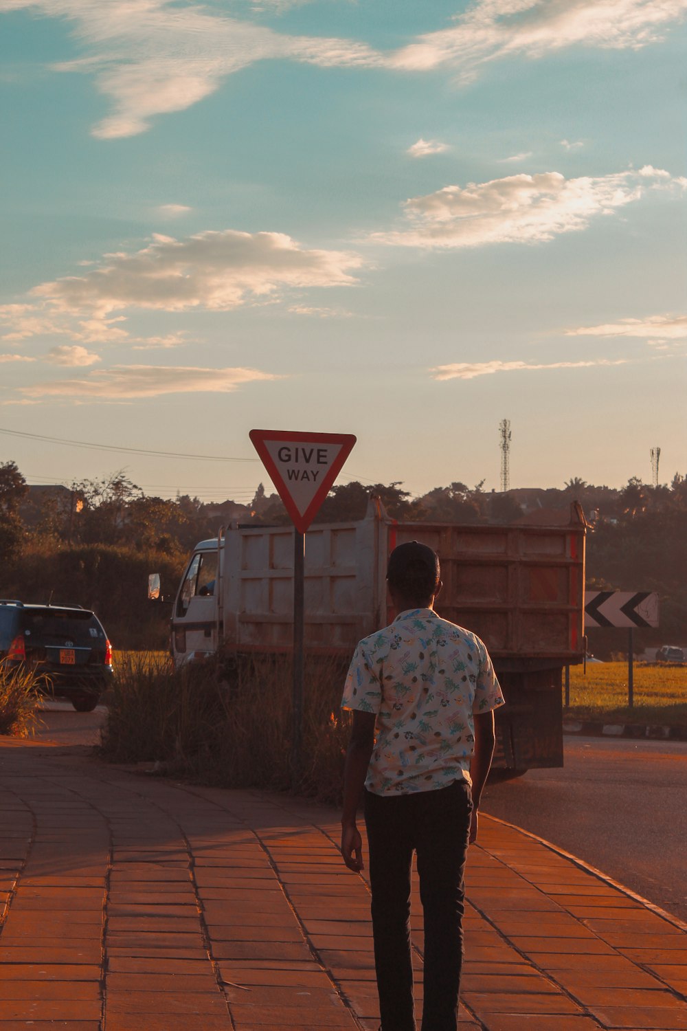 man walking on sidewalk near truck