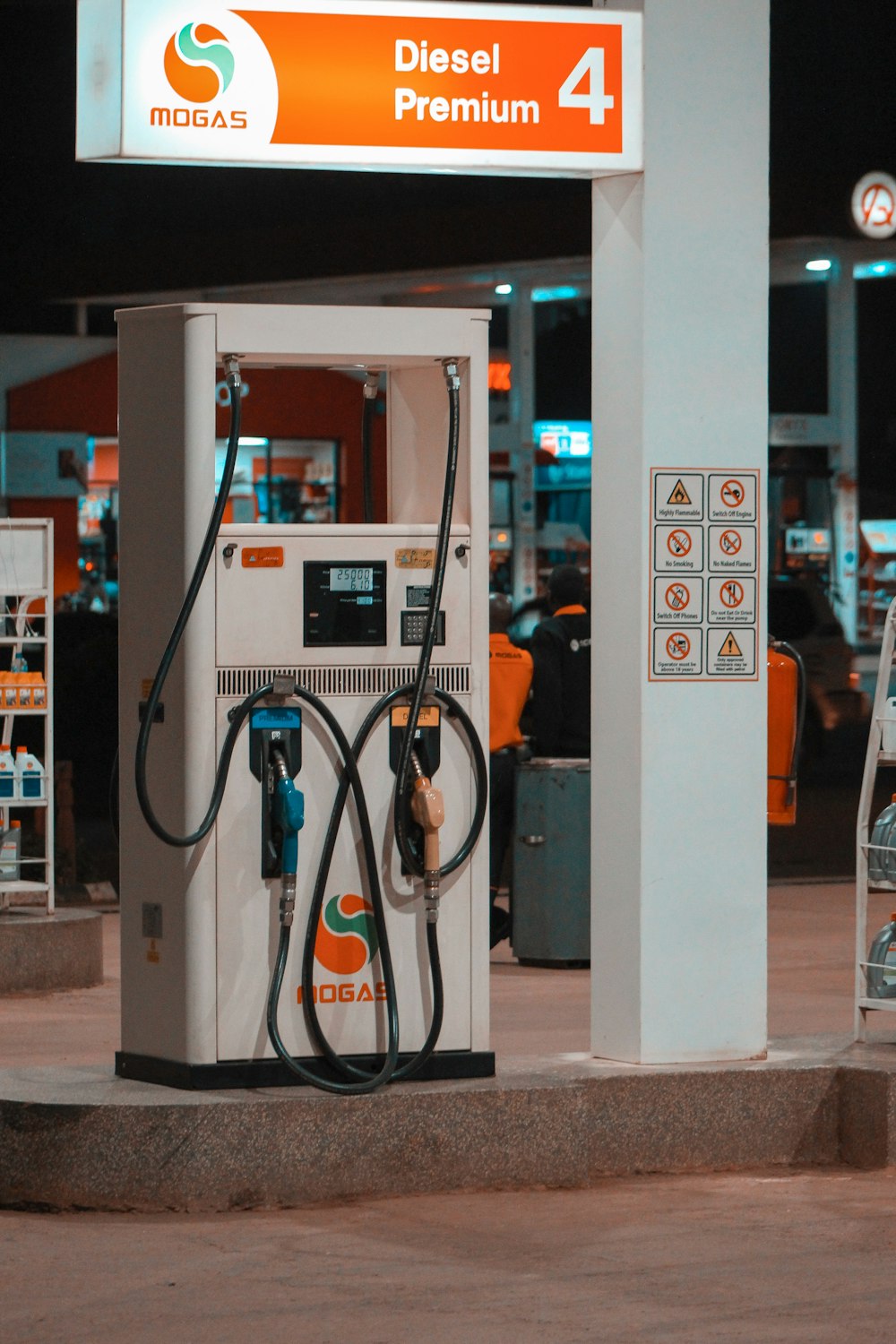 a gas pump at a gas station at night