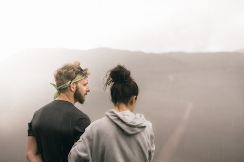 couple standing on the field photography