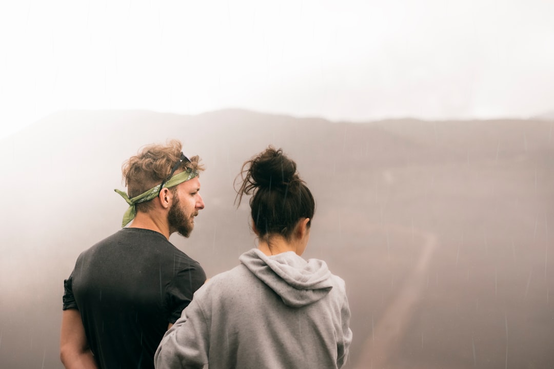 couple standing on the field photography