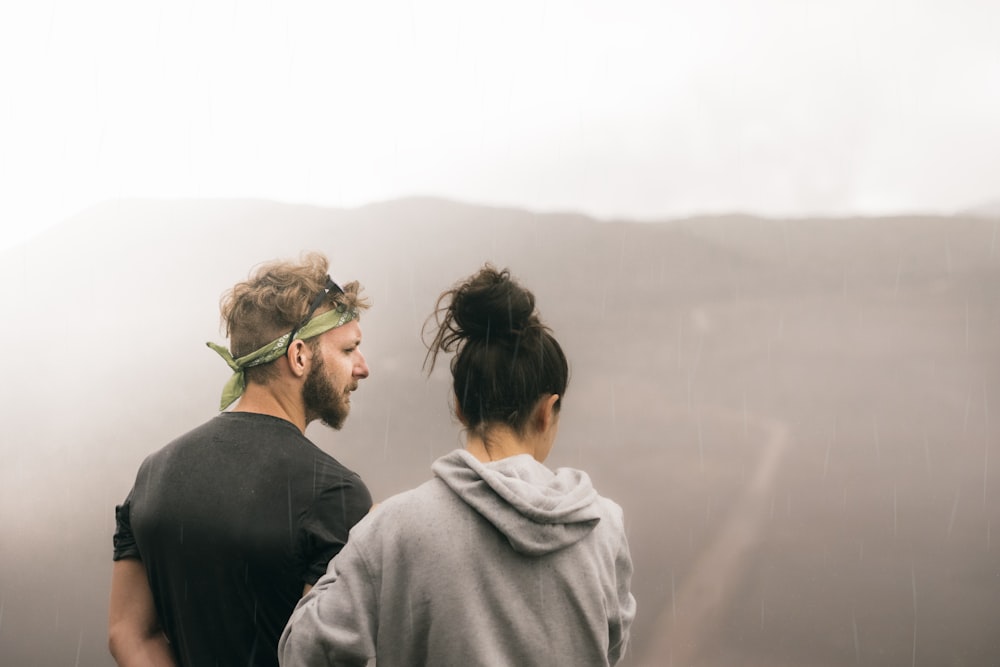 couple standing on the field photography