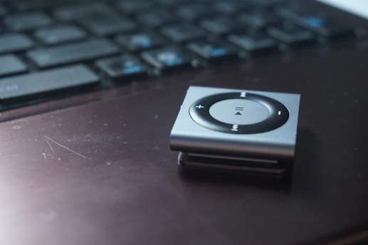 Close-up of a digital MP3 player with play, pause, and skip buttons