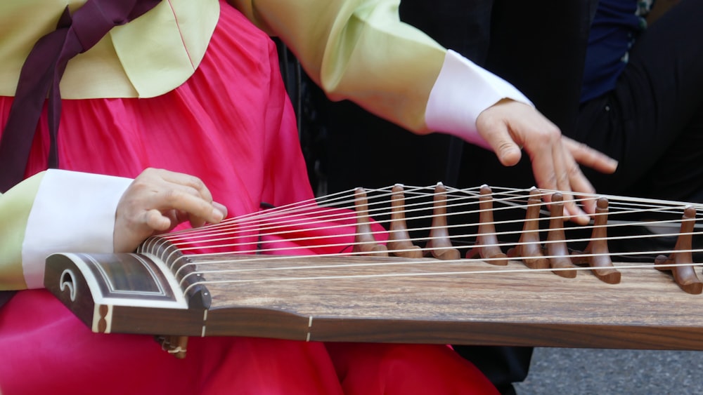 person playing brown string instrument