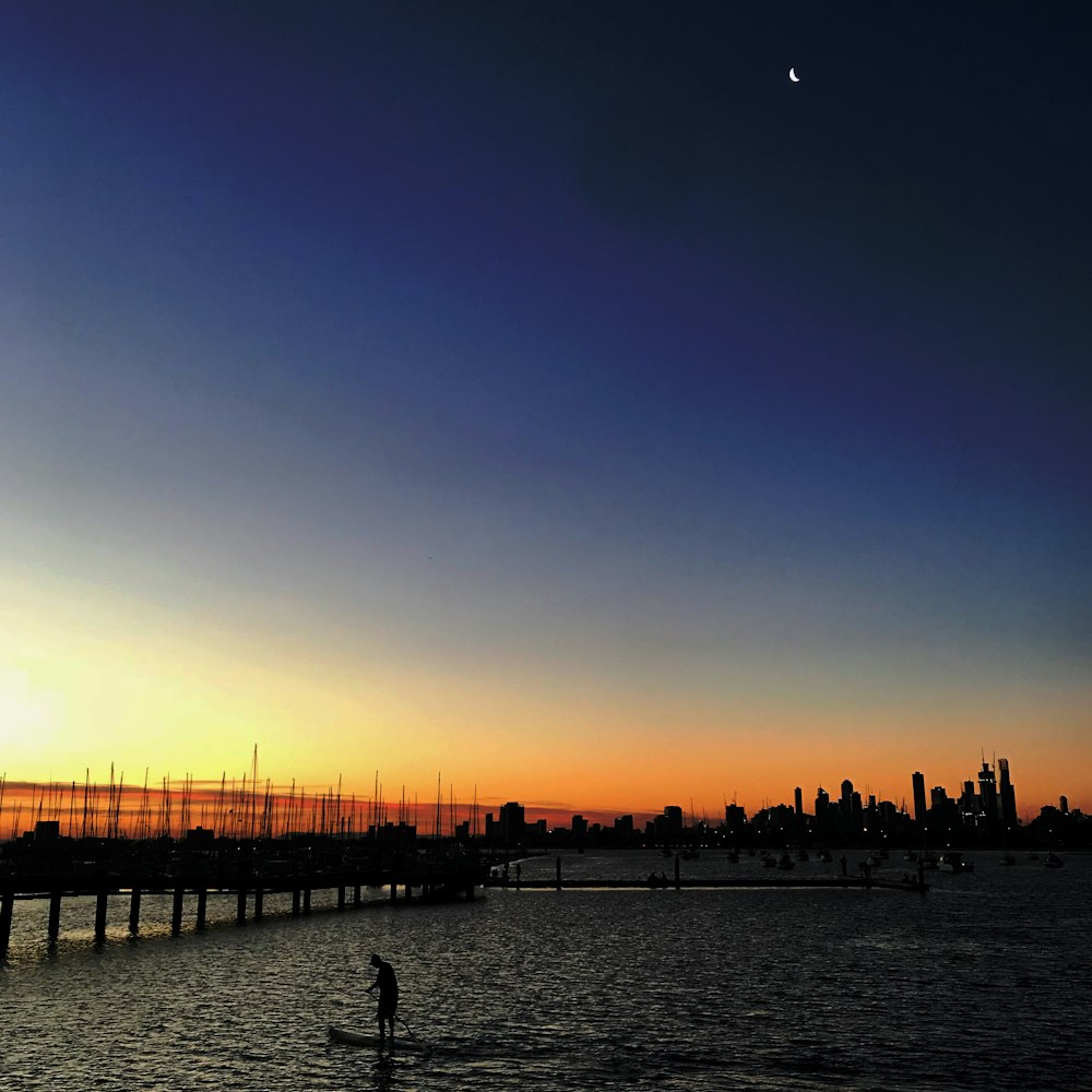 silhouette of city buildings near sea