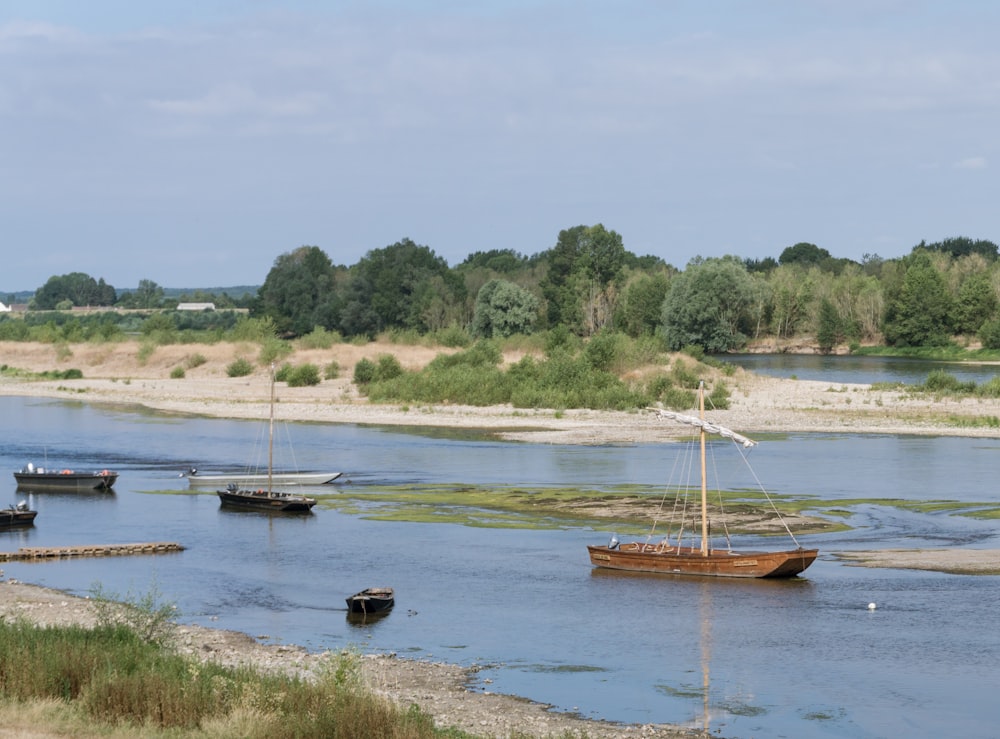 a group of boats floating on top of a river