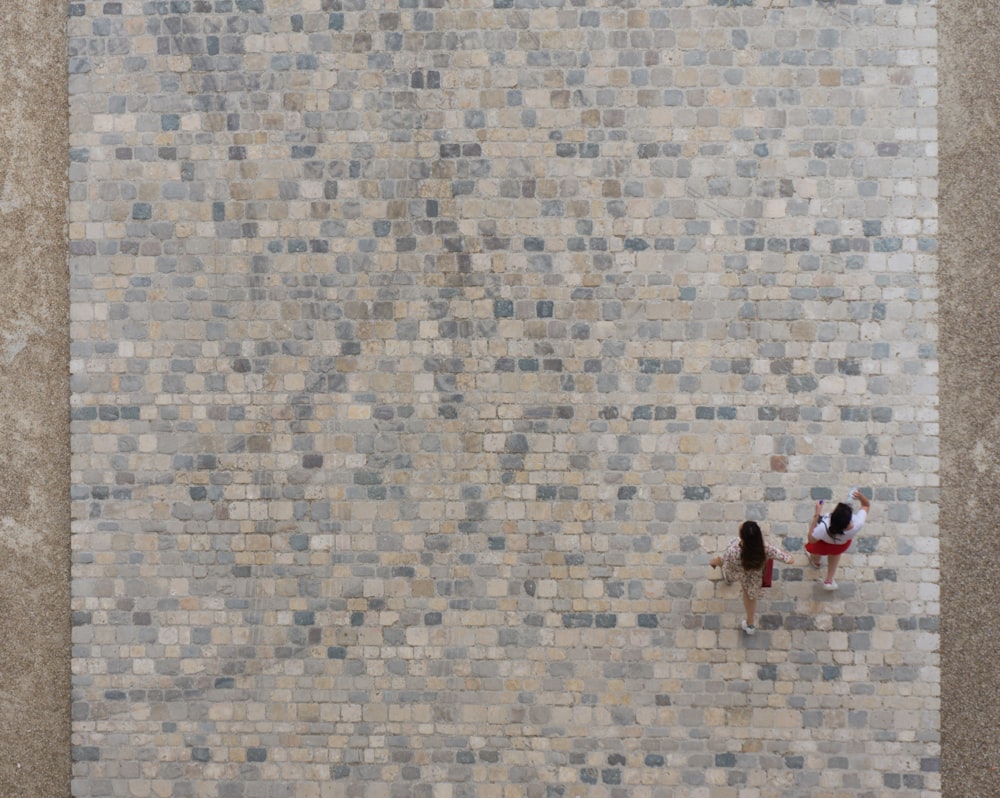 two women walking on pavement