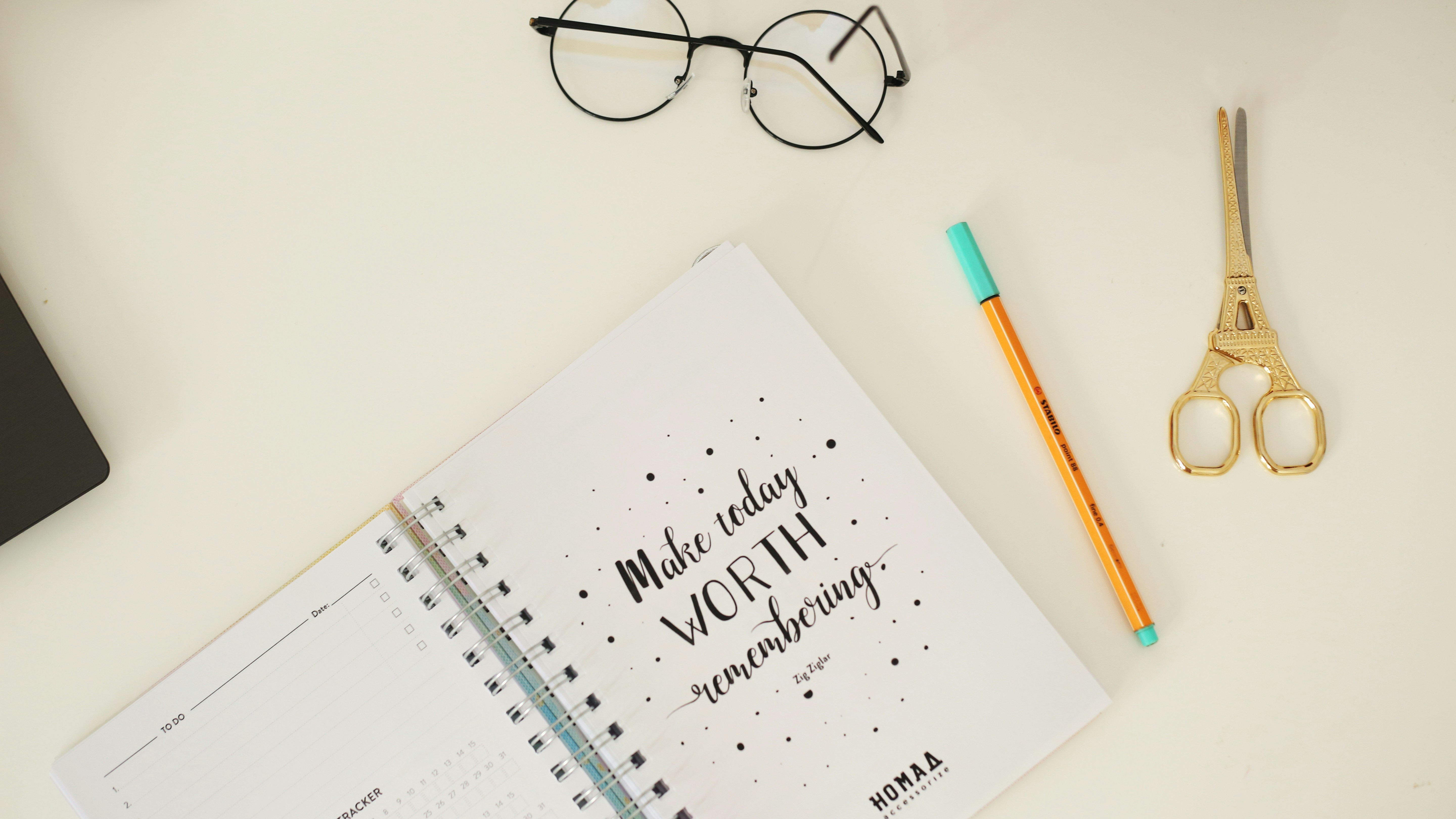 yellow pen and brass-colored scissor