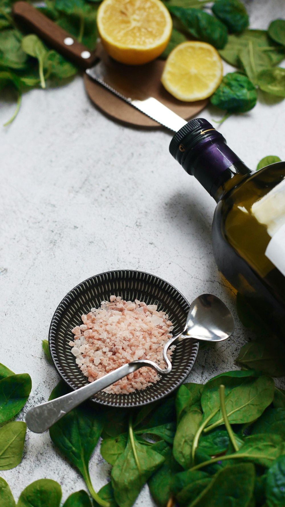 round black bowl beside wine bottle and leaves