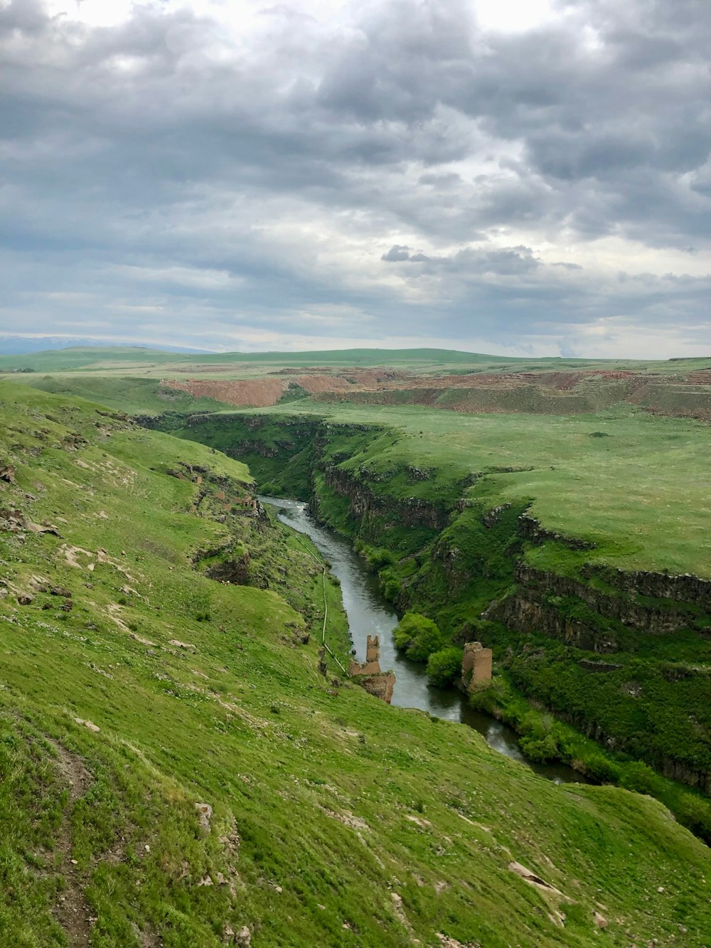 a river running through a lush green valley