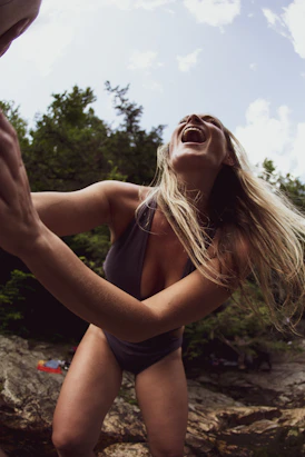 woman wearing gray swimsuit laughing