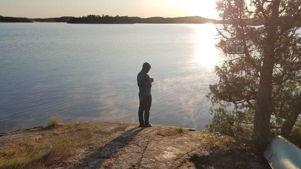 a person standing at the edge of a body of water