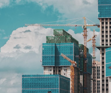 a group of tall buildings under a cloudy blue sky