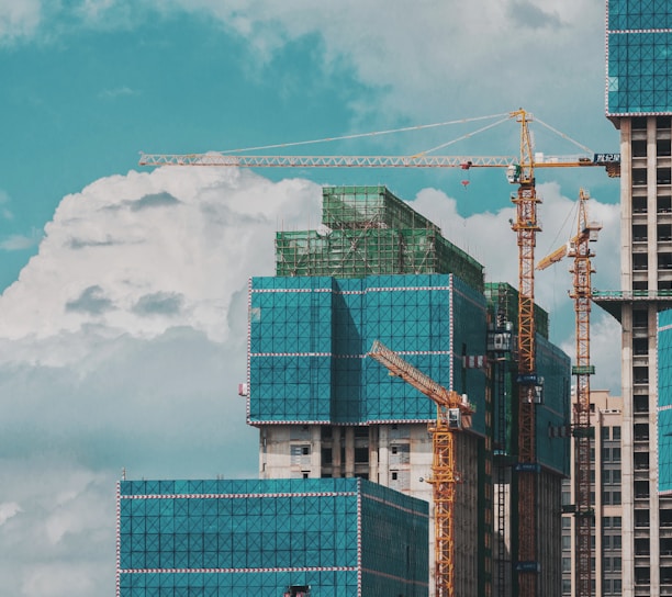 a group of tall buildings under a cloudy blue sky