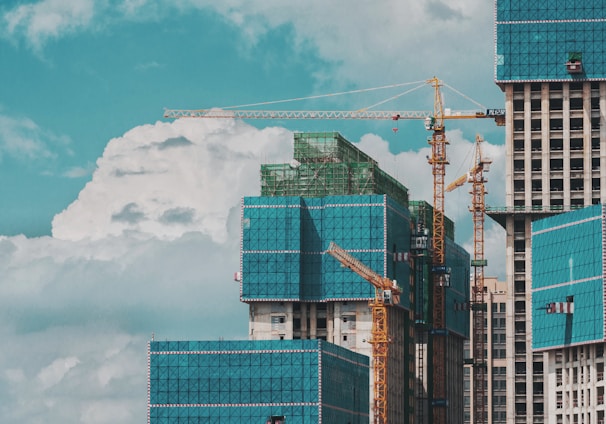 a group of tall buildings under a cloudy blue sky