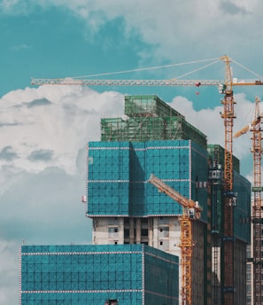 a group of tall buildings under a cloudy blue sky