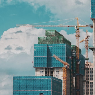 a group of tall buildings under a cloudy blue sky