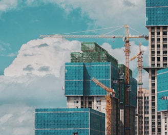 a group of tall buildings under a cloudy blue sky