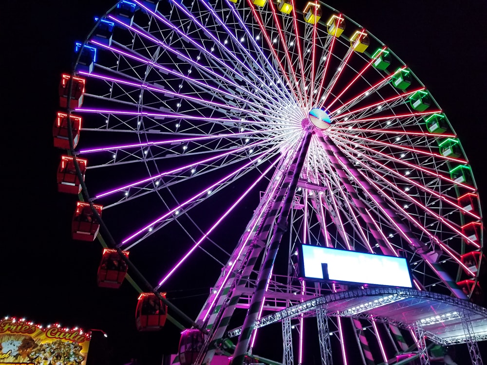 purple, green, and red lighted ferris-wheel during nighttime