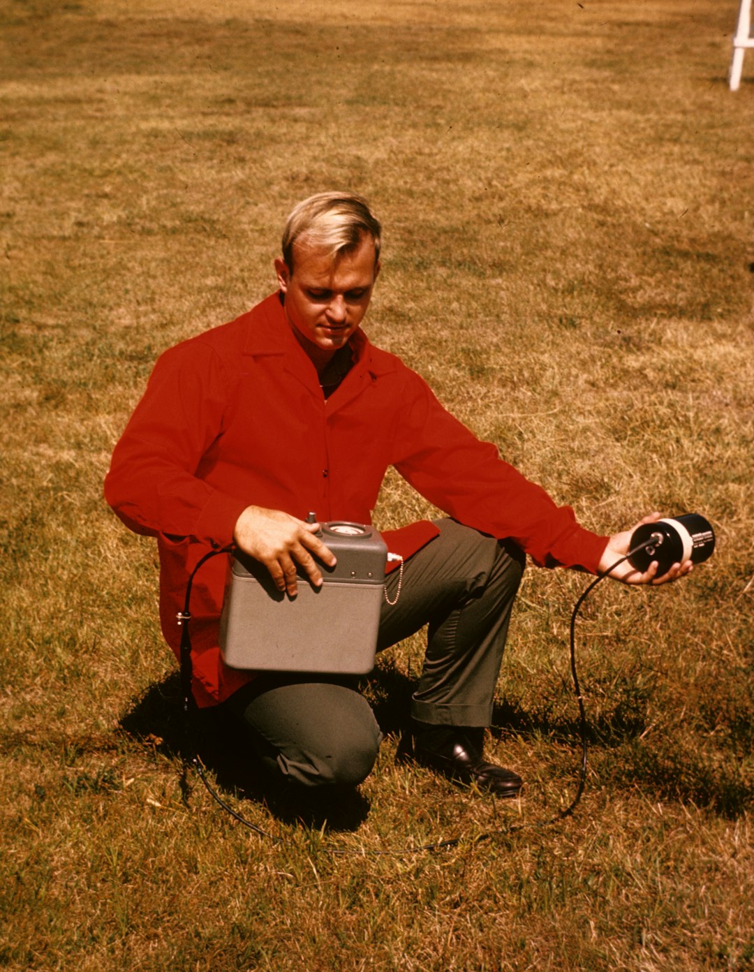 man holding gray electronic device