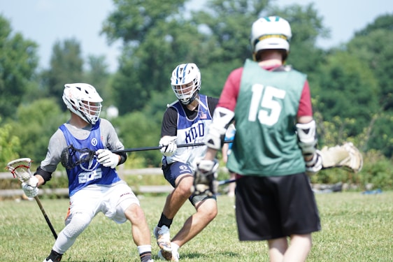 An athlete wearing a full set of colorful protective gear, ready to play on a sunny outdoor field.