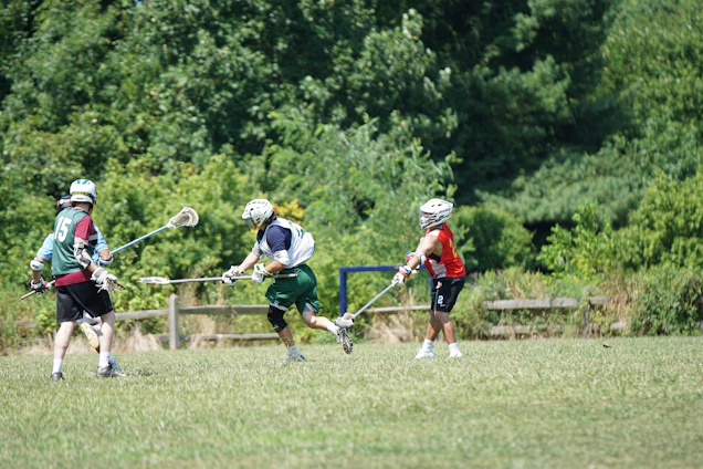 A vibrant lacrosse field with players in action during a match.