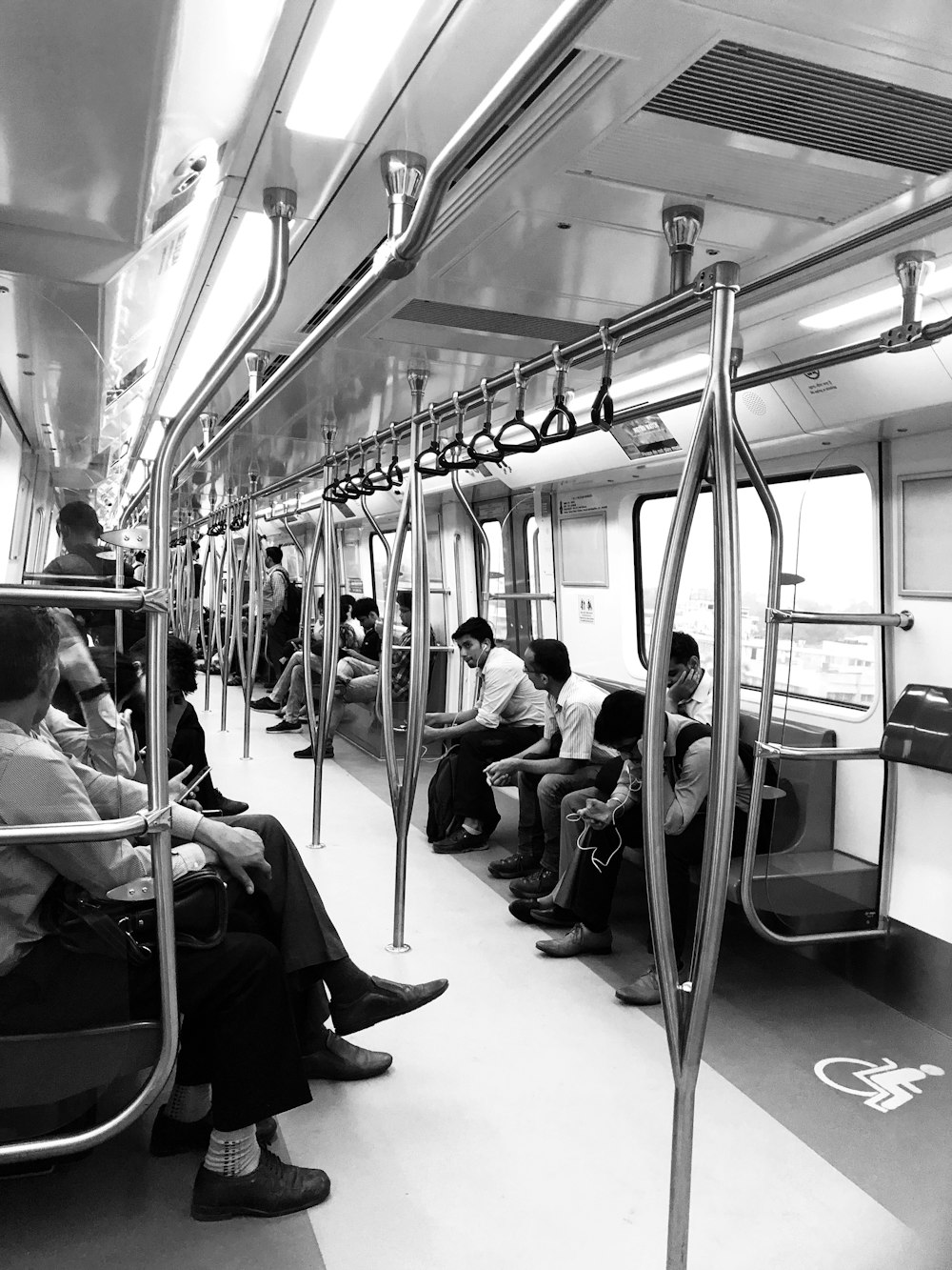 grayscale photography of people sitting inside train