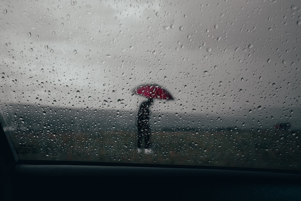 a person holding an umbrella in the rain