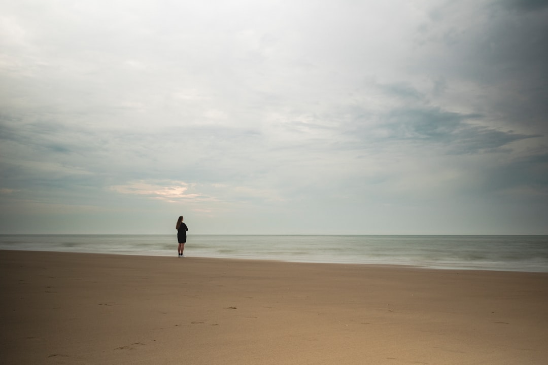 rule of thirds photography unknown person standing near body of water