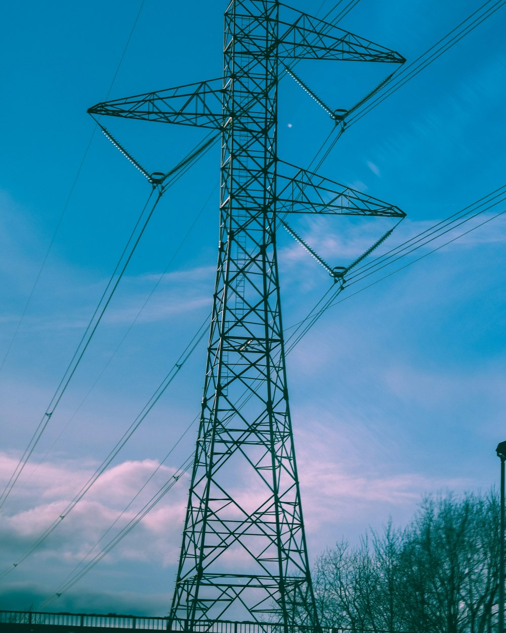 grey metal electric tower under blue sky