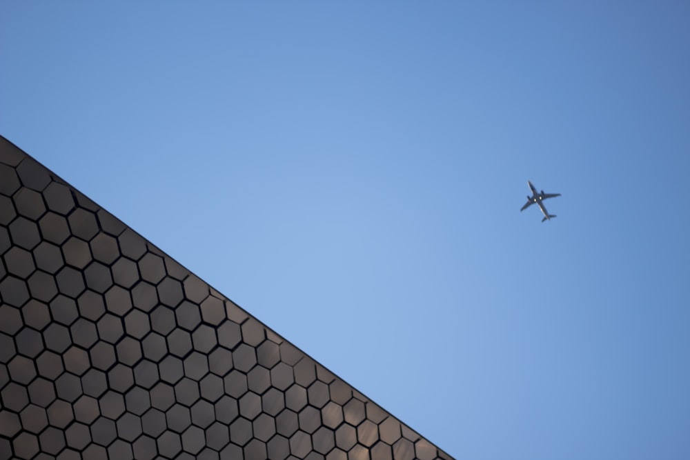 plane flying under clear blue sky during daytime