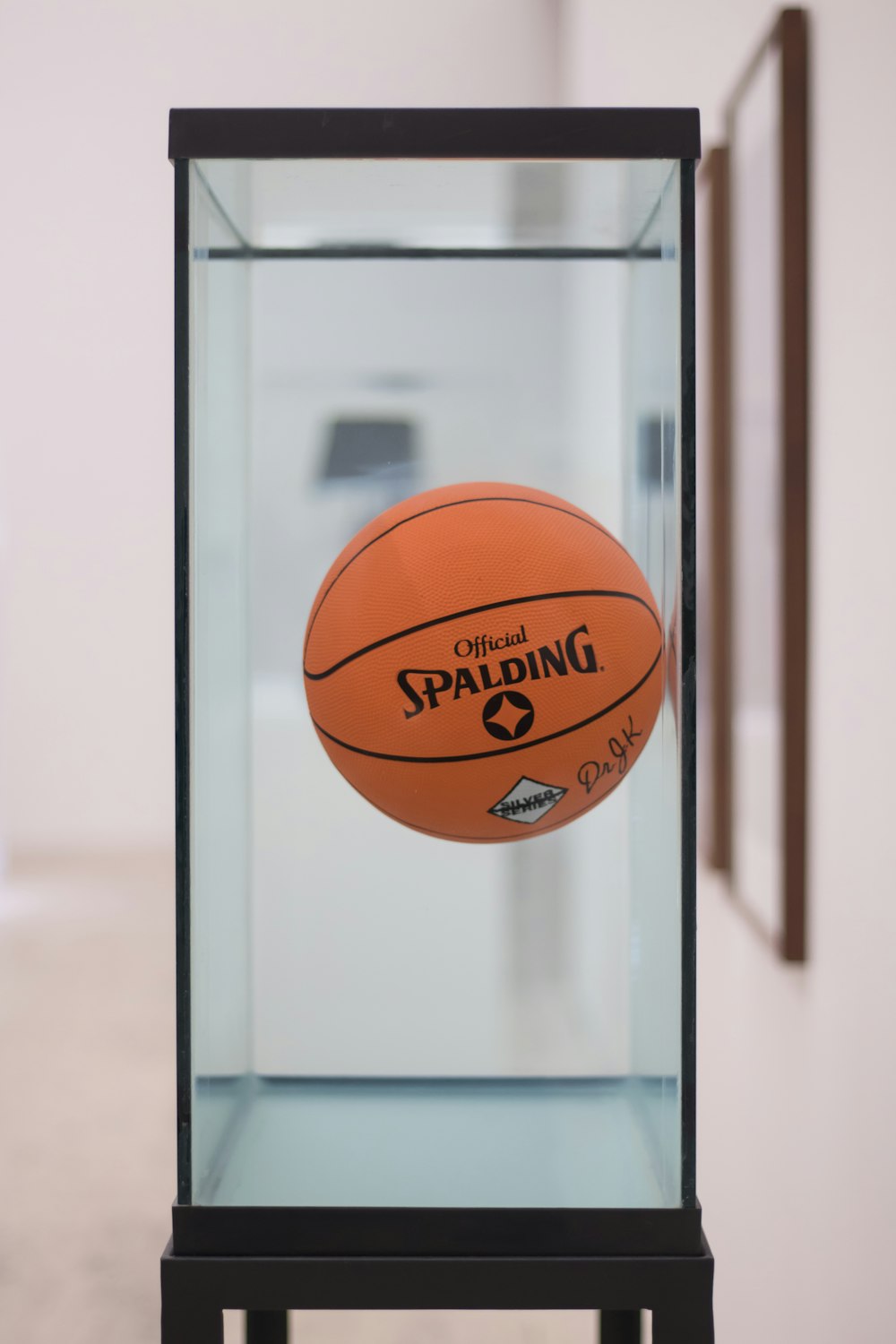 a basketball inside of a glass display case