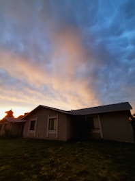 A stunning exterior shot of a home at sunset with warm lighting.