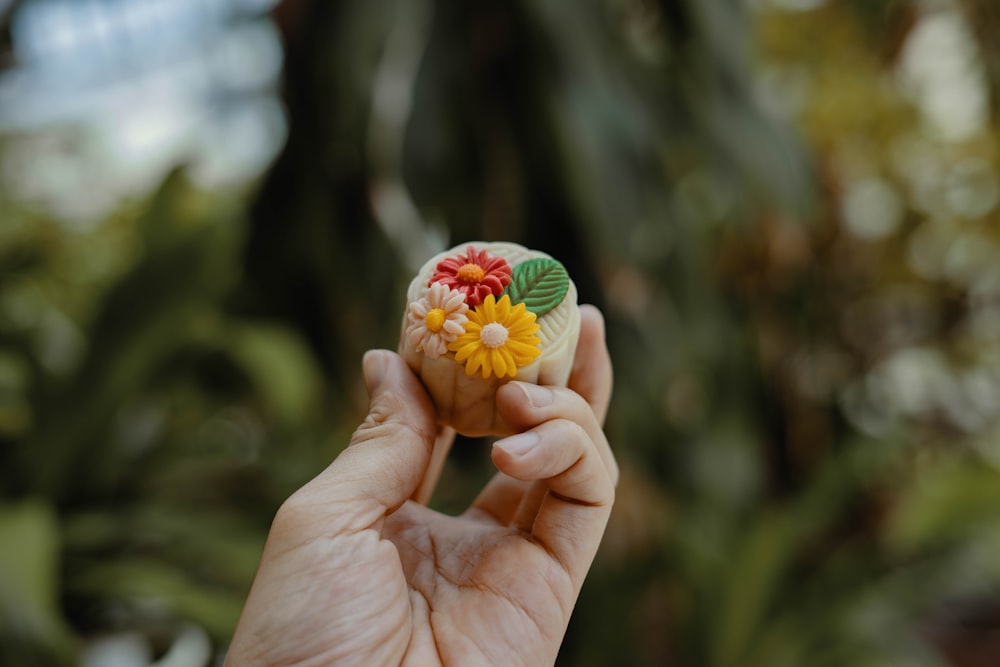 person holding floral accessory