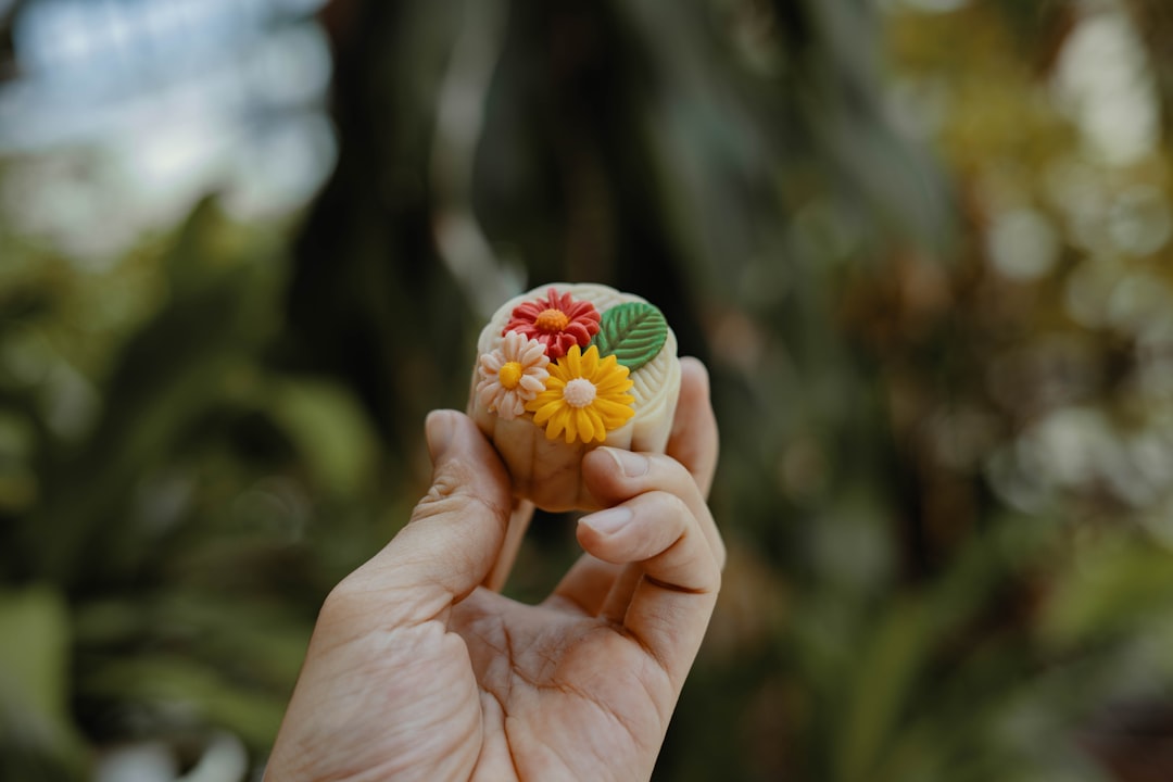 person holding floral accessory,