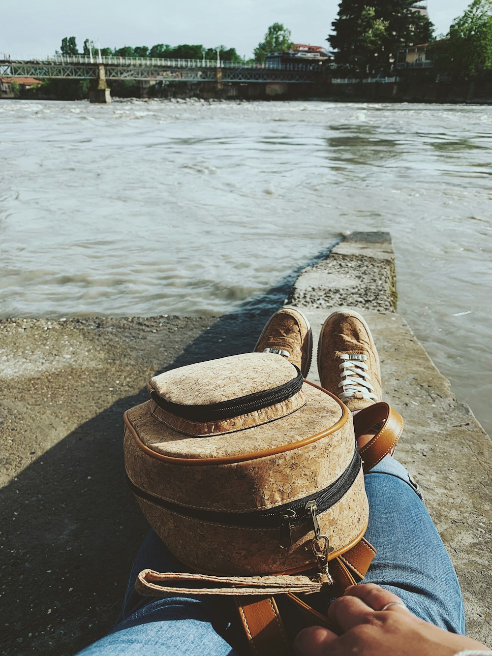 person sitting at the dock near body of water