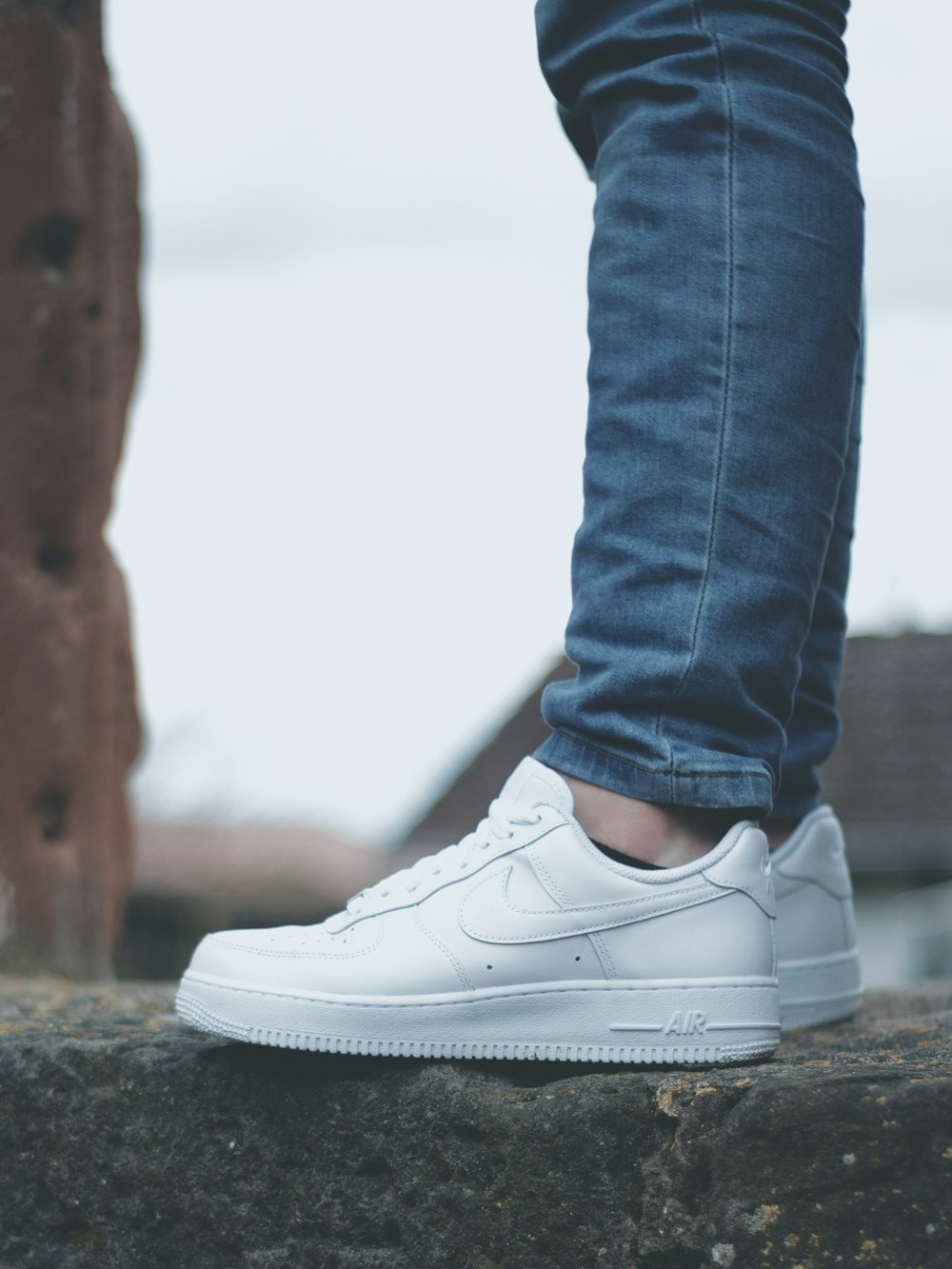 person in blue denim jeans wearing gray and pink nike sneakers photo – Free  Germany Image on Unsplash