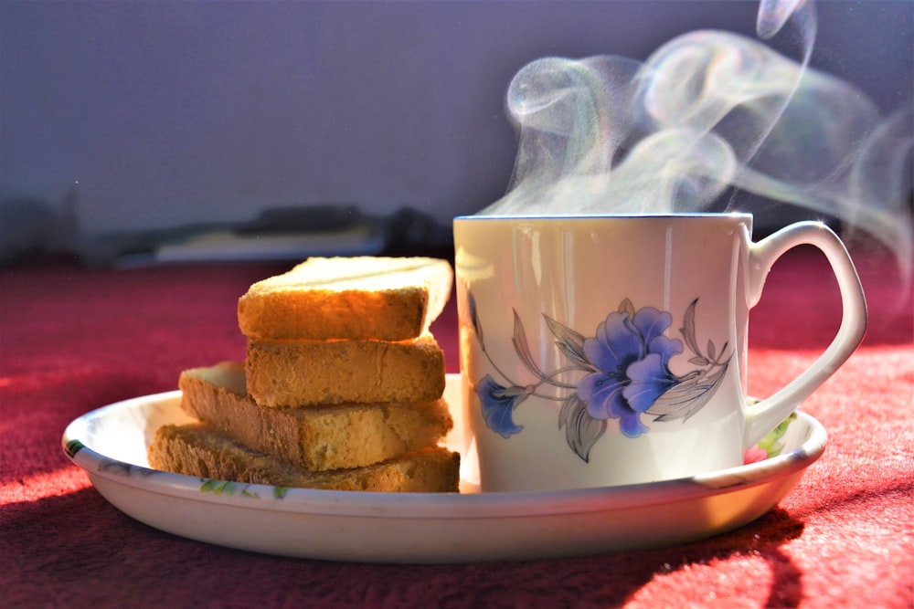 bread beside white floral mug