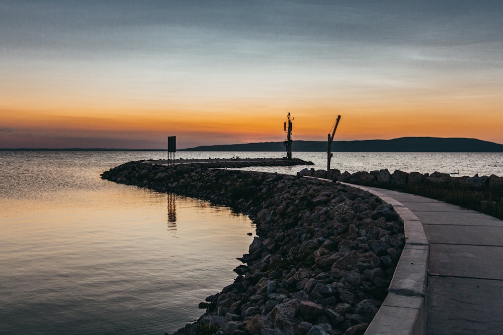 gray concrete dock during golden hour