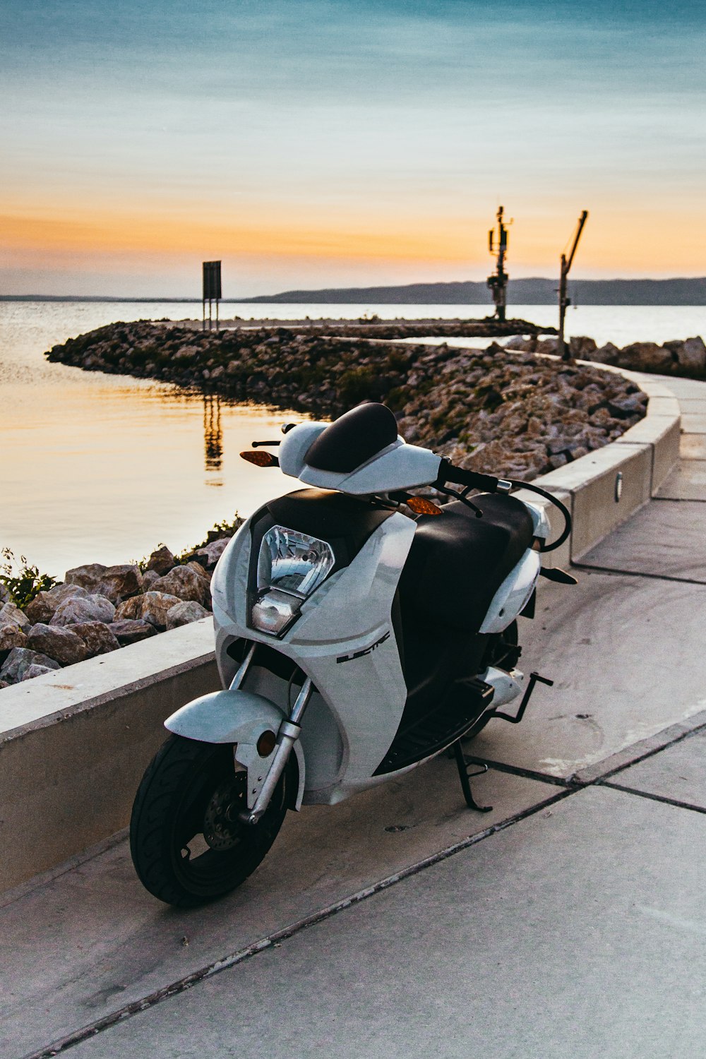 white scooter on concrete dock