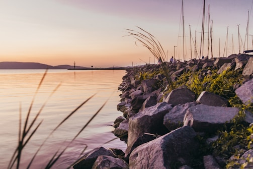 A soft pastel sketch of a quiet lakeside at sunset.