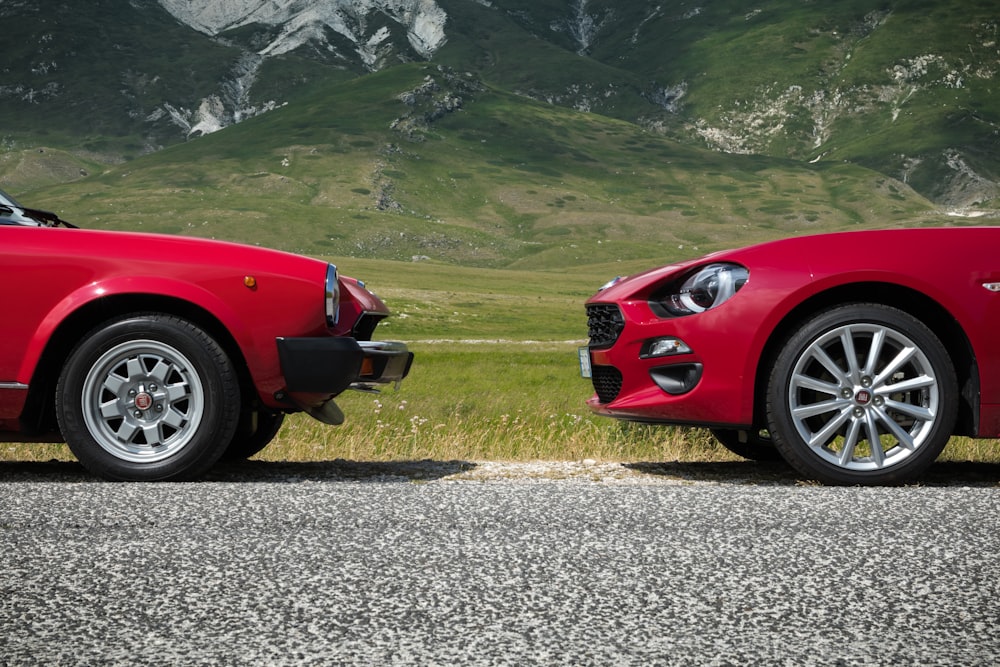 two red vehicle face each other at daytime