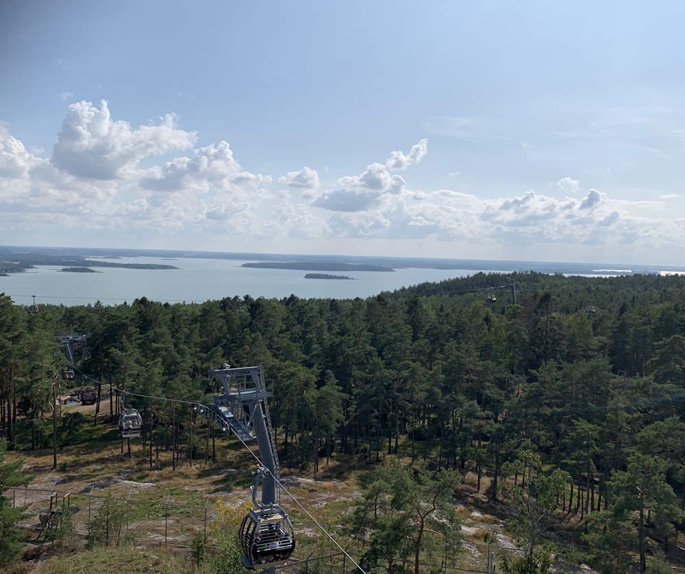 high-angle photo of gray transmission towers and green trees