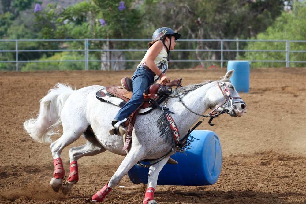 woman riding horse during daytime