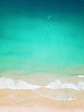 aerial photo of seashore clear green water