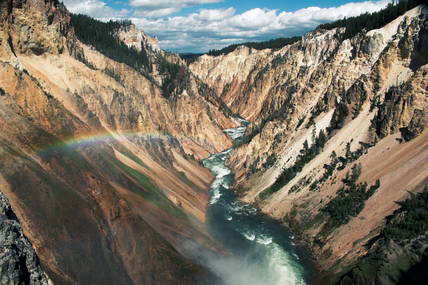 Aerial view of a river winding between mountains in Yellowstone National Park