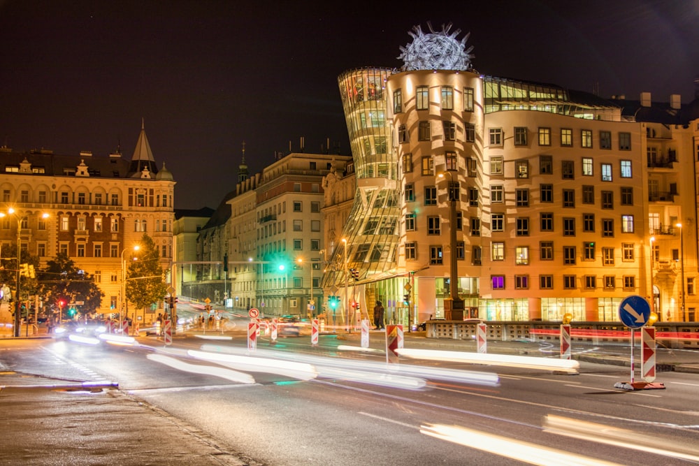 lighted brown concrete building at night