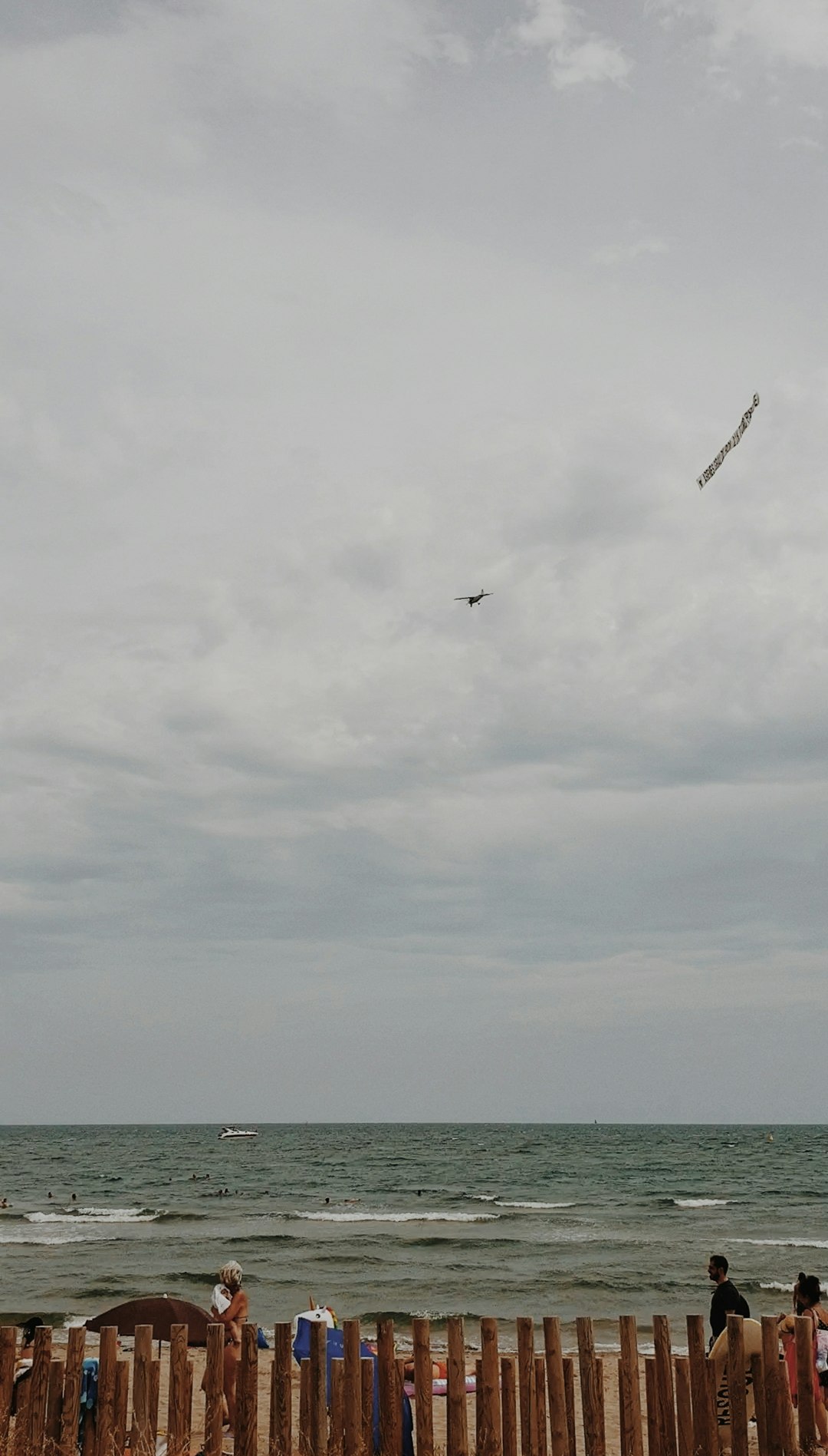 people on beach under white clouds