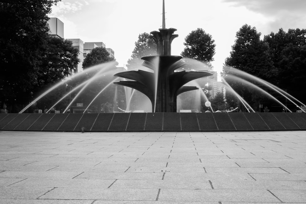 grayscale photo of water fountain