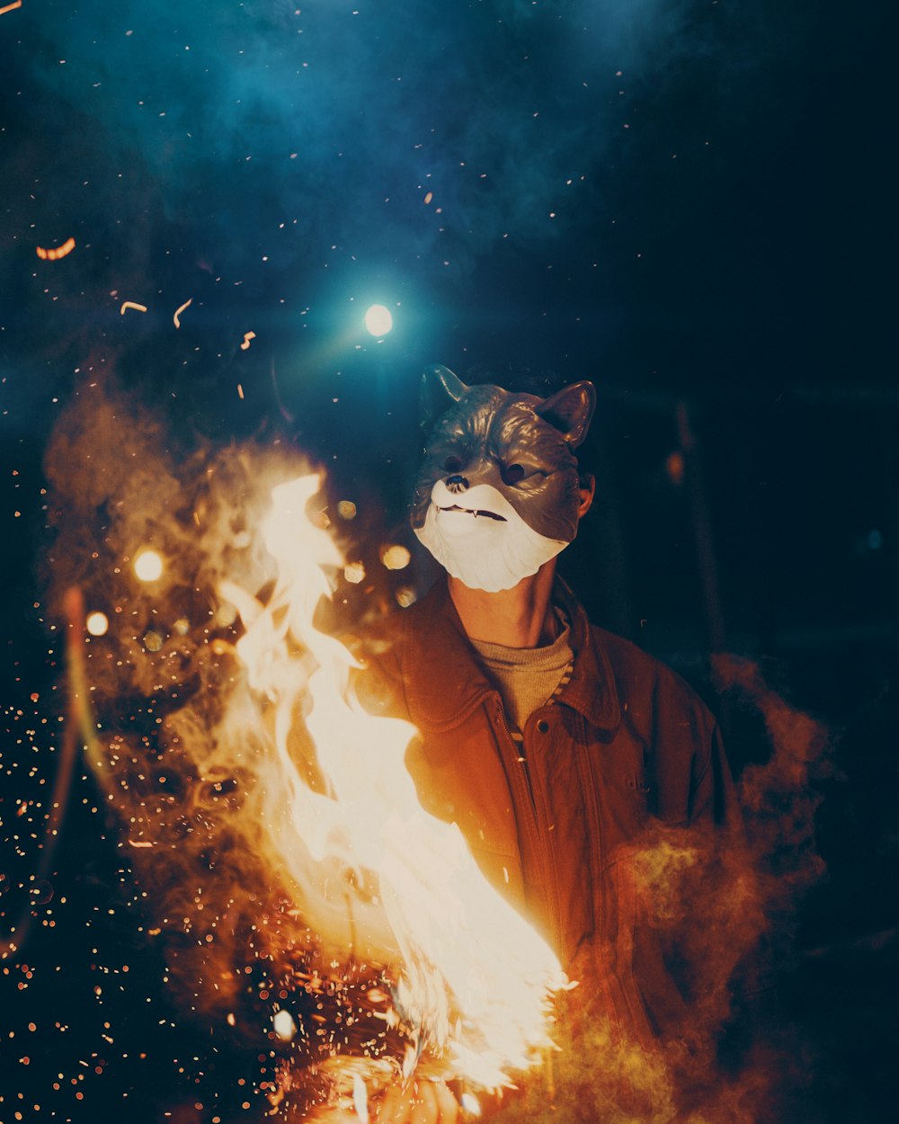 man in fox mask wearing black jacket