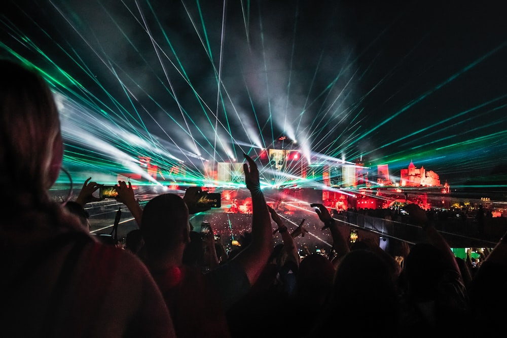 people raising hands in front of stage